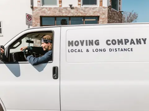 The side of a white moving van lettered Moving Company, Local and Long Distance