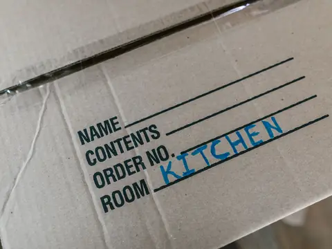 A moving box labeled Kitchen, close up